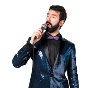 handsome man with sequin jacket singing with microphone